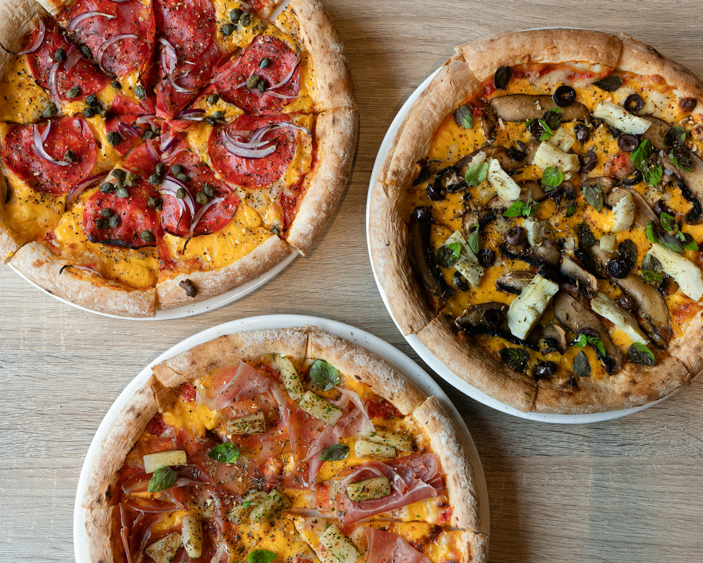 Three pizzas from above. Photo