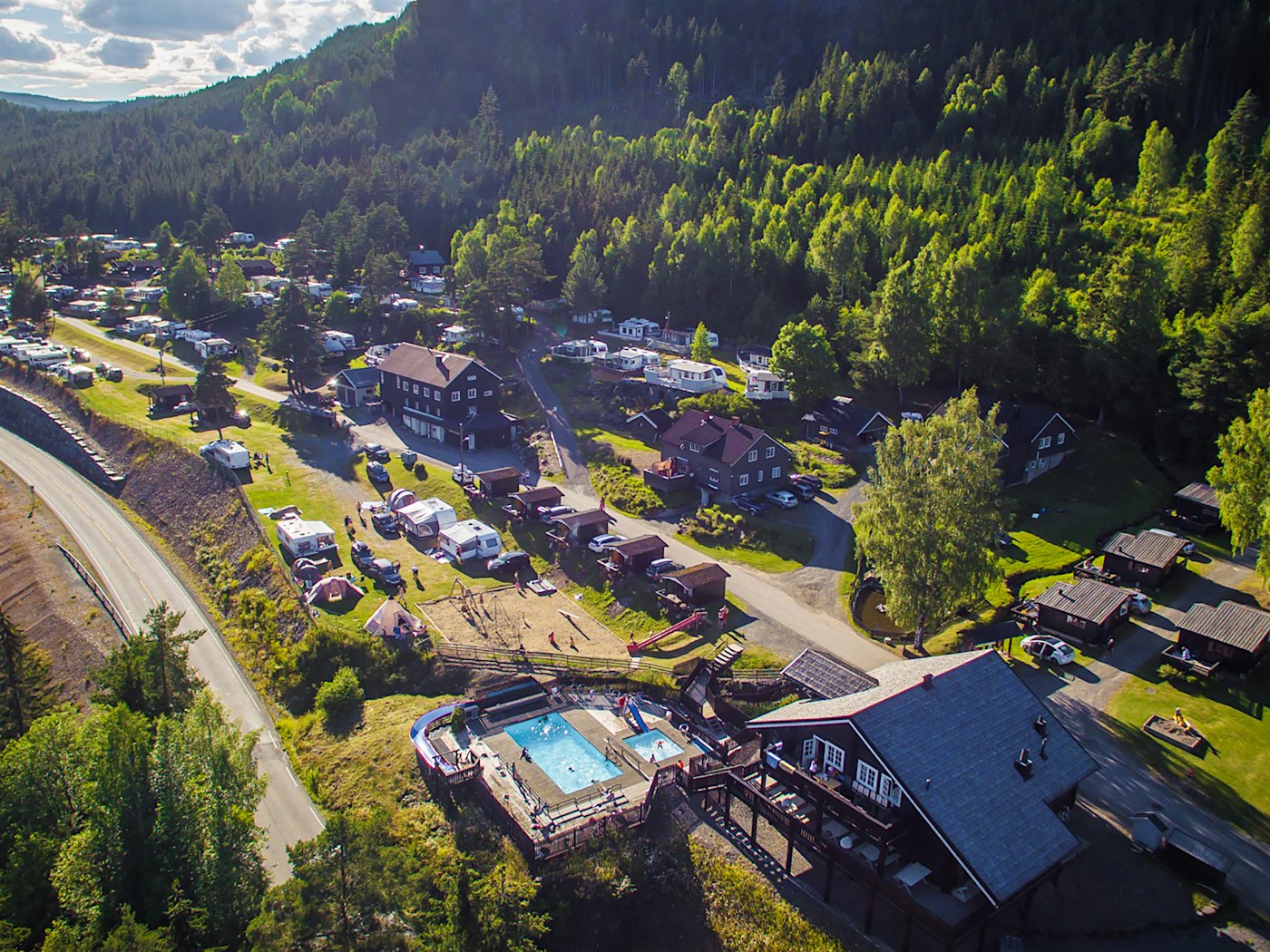 drone image of the restaurant, pool area, playground, cabins and camping pitches