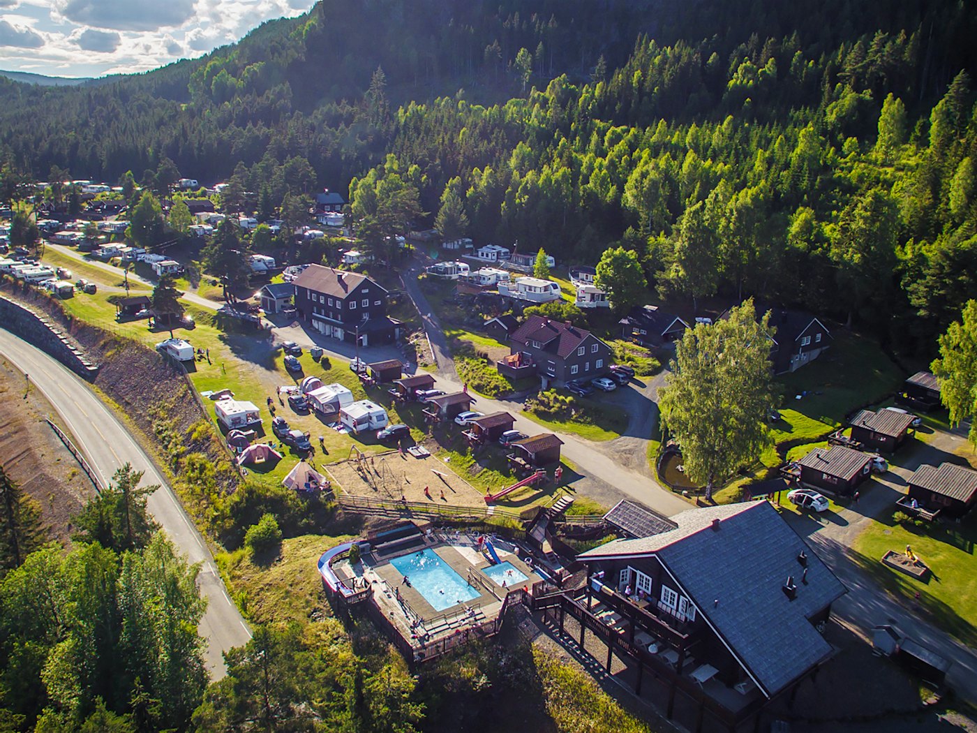 drone image of the restaurant, pool area, playground, cabins and camping pitches