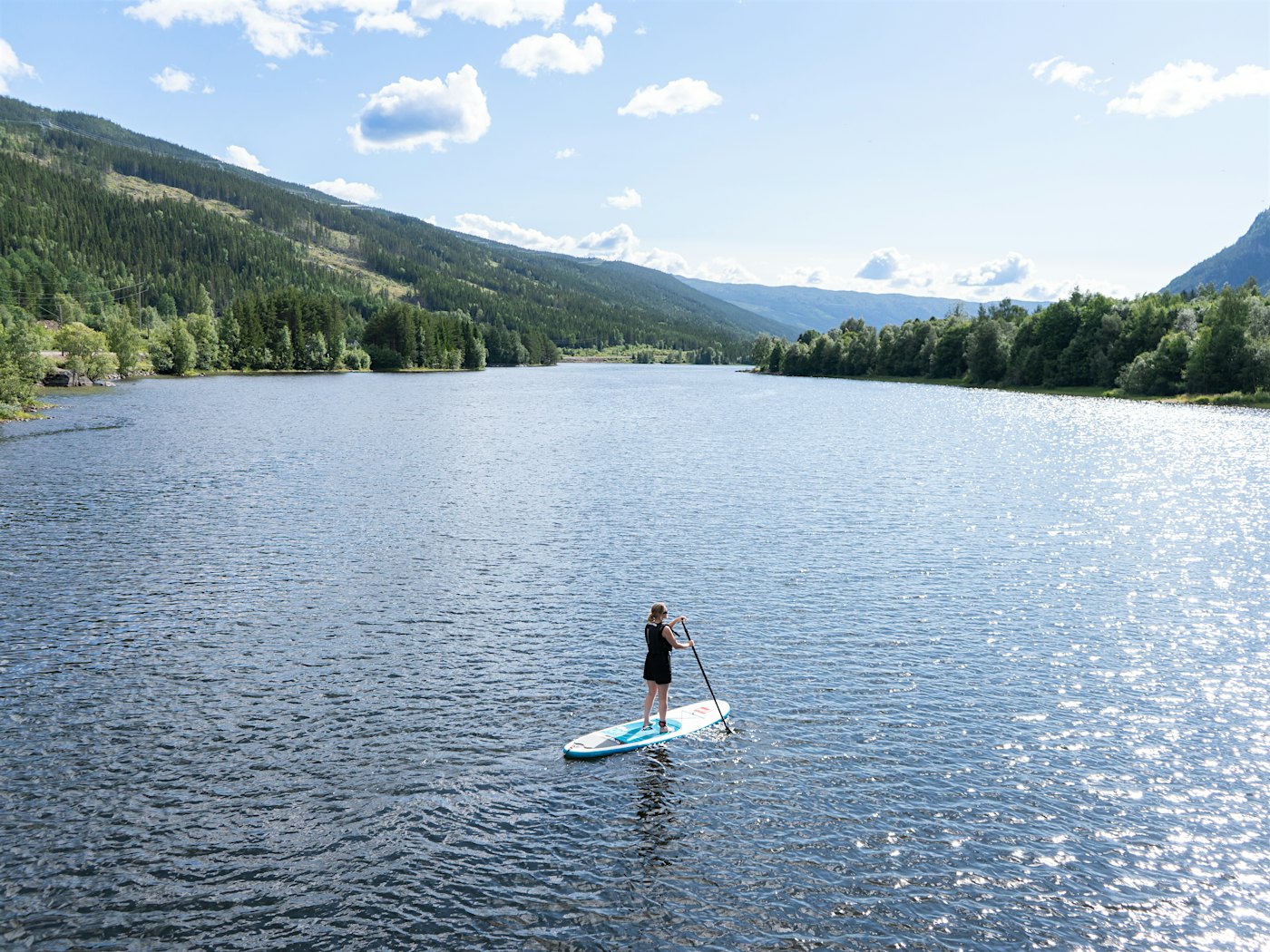 Girl on a SUP board on the river in Hallingdal. Photo