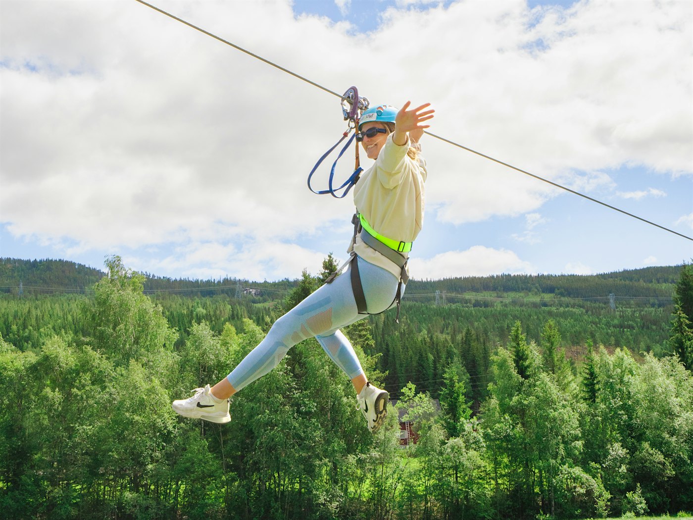 Lady in zipline over the river. Photo