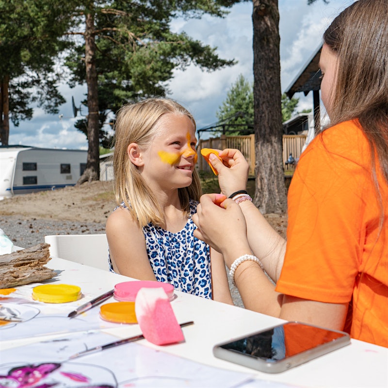 Girl gets face paint and smiles. Photo